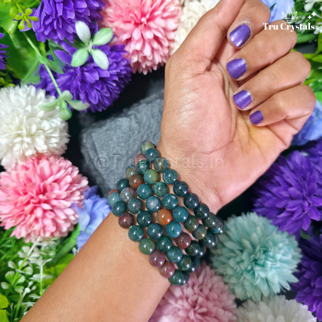 Blood Stone Bracelet worn on hands with floral background