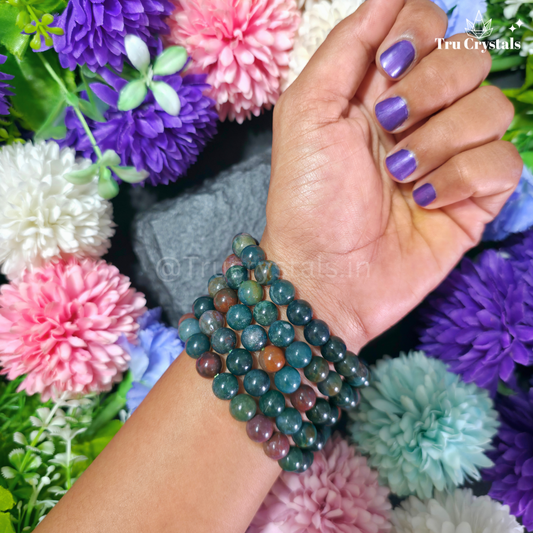 Blood Stone Bracelet worn on hands with floral background