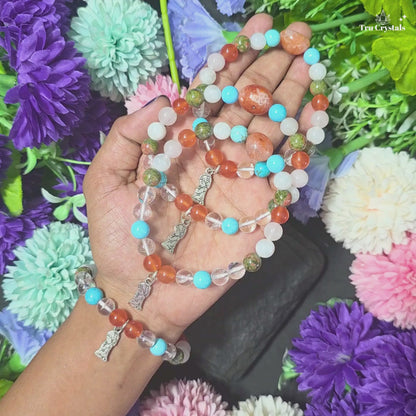 A multicolored Fertility bracelet  featuring Turquoise , carnelian , Unakite , rose quartz , Clear quartz and moonstone gemstones displayed on girl's wrist